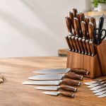 16-piece Japanese knife set with wooden block, assorted kitchen knives, scissors, and accessories on a wooden countertop in a modern kitchen.